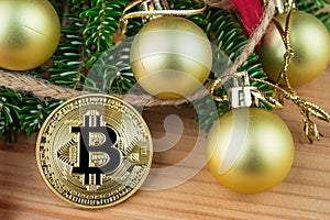 Christmas decoration - golden baubles, poinsettia, fir branches with Bitcoin