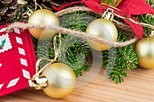 Christmas decoration - golden baubles, poinsettia, fir branches and cones