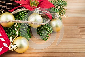 Christmas decoration - golden baubles, poinsettia, fir branches and cones