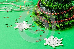 Christmas decoration on the green background. Ornaments, snowflakes, stars. Christmas tree