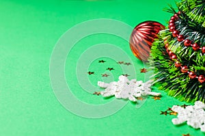 Christmas decoration on the green background. Ornaments, snowflakes, stars. Christmas tree