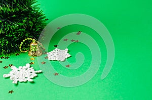 Christmas decoration on the green background. Ornaments, snowflakes, stars. Christmas tree