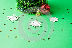 Christmas decoration on the green background. Ornaments, snowflakes, stars. Christmas tree
