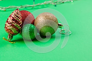 Christmas decoration on the green background. Ornaments, snowflakes, stars. Copy space