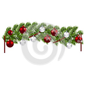 Christmas decoration. Green branches of a Christmas tree with red and silver balls and snowflakes on a white background