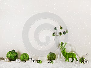 Christmas decoration: green reindeer on wooden white background.