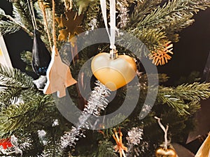 christmas decoration hanging on fake christmas tree