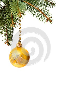 Christmas decoration. Hanging golden yellow ball on christmas tree on a white background with space for text