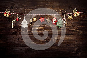 Christmas decoration and hanging on a rope with old wooden background