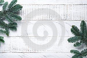 Christmas Decoration. Holiday Decorations with gold baubles, cones, bells, fir branches and present on the old white wooden board