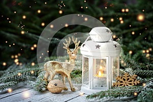 Christmas decoration with lantern, gold snowflake and balls, fir branches and ornaments on dark background