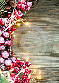 Christmas decoration on the left side of wooden background with lights