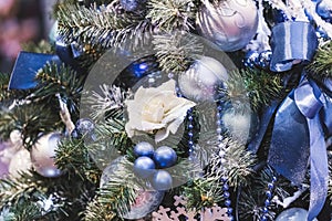 Christmas decoration with a lot small blue balls and decorative white rose