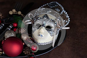 Christmas Decoration ornaments on black plate with silver cutlery set , rustic copper background