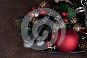 Christmas Decoration ornaments on black plate with silver cutlery set , rustic copper background