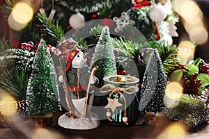 Christmas decoration with  penguin figurine and a candle in glass