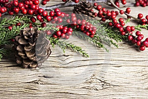 Christmas decoration of pine cone and red winterberry photo