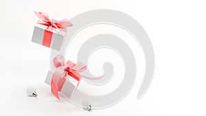 Christmas decoration red background. White gifts with red ribbon and New Year balls in xmas decoration on white background for