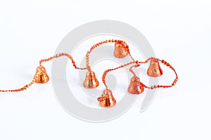 Christmas decoration with red bells on rope isolated on white