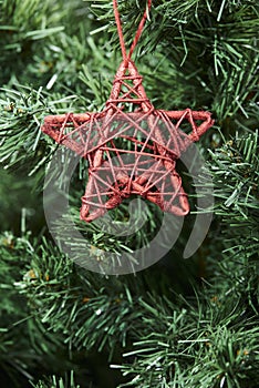 Christmas decoration: red decorative star hanging on a tree