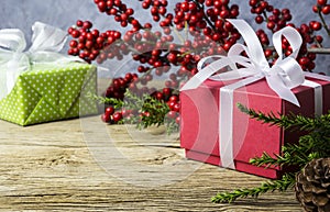 Christmas decoration of red gift box and red winterberry photo