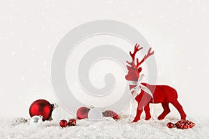 Christmas decoration: red reindeer on wooden white background.