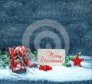 Christmas decoration red stars and antique baby shoes in snow