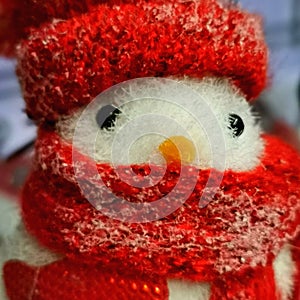 A Christmas decoration representing a little bird with a red hat and scarf