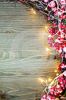 Christmas decoration on the right side of wooden background with lights