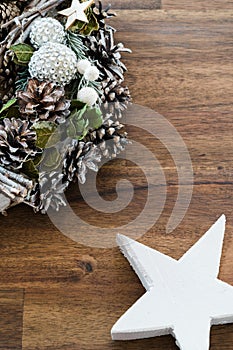 Christmas decoration on a rustic brown wooden background with a white wood star