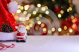 Christmas decoration with Santa hat and toy. Winter season holiday with light bokeh