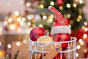 Christmas decoration with Santa hat and toy. Winter season holiday with light bokeh