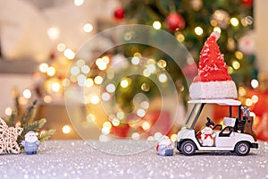 Christmas decoration with Santa hat and toy. Winter season holiday with light bokeh
