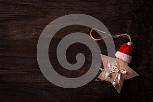 Christmas decoration in the shape of star with Santa Claus hat