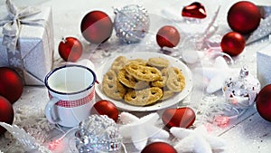 Christmas decoration with silver gifts red bubbles and homemade cookies and milk