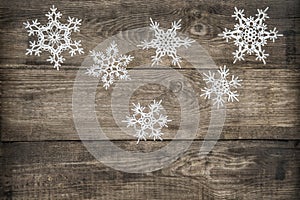 Christmas decoration snowflakes on rustic wooden background