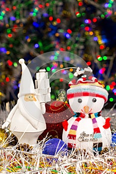 Christmas decoration, Snowman, Santa, balls, tinsel on blurred lights background