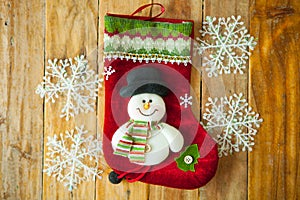 Christmas decoration stocking and snow flake hanging over rustic