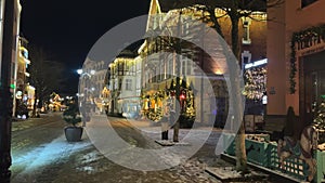 christmas decoration street town city night scene. flickering lights on building