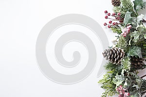 Christmas decoration, styled fir branches, pine cones, garland on white background. Top view with copy space