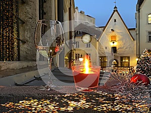 Christmas decoration in Tallinn old town red candle light glass of  champagne night windows blurred on medieval street in Estonia