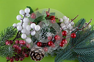 Christmas decoration. Top view on green pine tree branch, cone, red, white winter berries. Happy new year concept