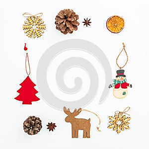 Christmas decoration - tree, snowflakes, snowman and pine cones on white. Flat lay, top view. New Year frame concept