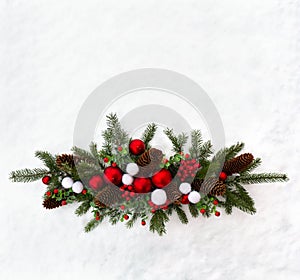 Christmas decoration. Twigs christmas tree, christmas balls, cones spruce and red berries on snow with space for text. Top view,