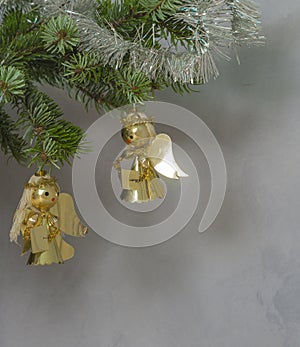 Christmas decoration two golden angel on spruce tree branch