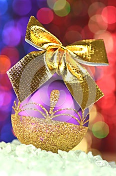 Christmas decoration, violet Christmas ball with golden bow