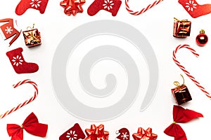 Christmas decoration white background. Stocking, gifts, winter tree, ribbon and bow in shape frame on white background for