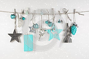 Christmas decoration in white an light blue on wooden background