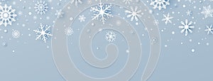 Christmas decoration with white paper cut snowflakes and falling snow. Winter Holiday greeting card. Luxury blue long