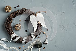 Christmas decoration with wicker ring, laces, angel wings